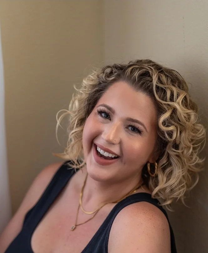 Lexi Holder, founder of Praxis Institute Holdings, laughing in a casual portrait